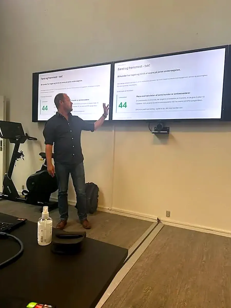 A SurveyGauge advisor presents the results to the staff at FH Group